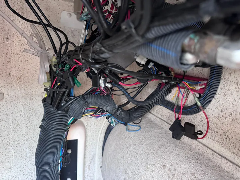 Slide: The Image of Wiring system inside a 2021 Carolina Skiff Ultra Elite 24 boat, showcasing complex electrical connections. - 35