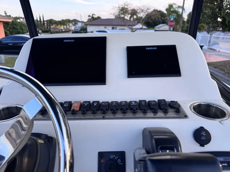 Slide: The Image of 2021 Carolina Skiff Ultra Elite 24 dashboard with Simrad displays and control panel. - 39