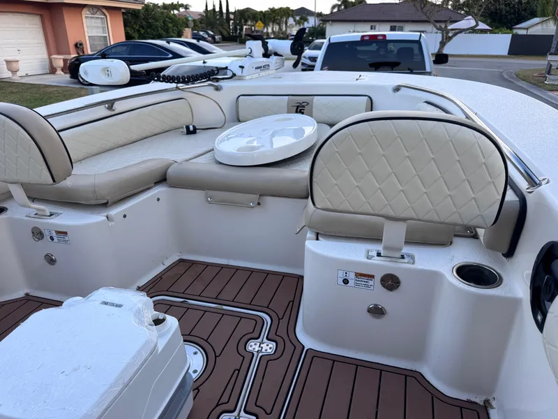 Slide: The Image of 2021 Carolina Skiff Ultra Elite 24 boat interior with beige seating and wood-patterned flooring. - 41