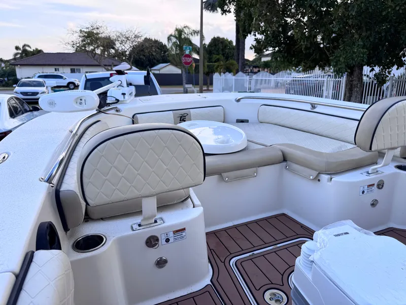 Slide: The Image of 2021 Carolina Skiff Ultra Elite 24 boat interior with cushioned seating and wood-style flooring. - 44