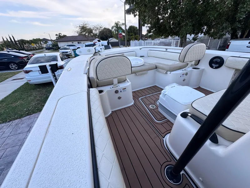 Slide: The Image of 2021 Carolina Skiff Ultra Elite 24 boat interior with cushioned seating and wood-style flooring. - 49