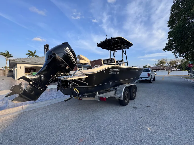 Slide: The Image of 2021 Carolina Skiff Ultra Elite 24 boat on trailer, parked on residential street. - 8