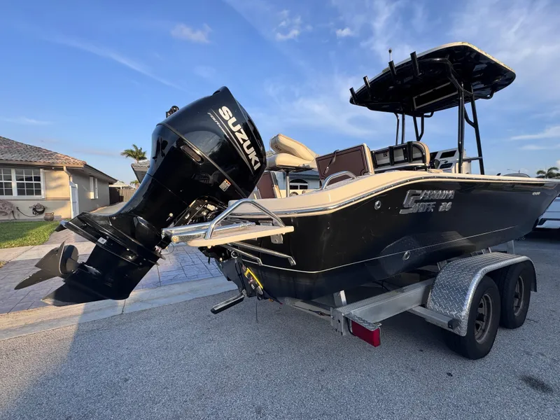 Slide: The Image of 2021 Carolina Skiff Ultra Elite 24 boat with Suzuki outboard motor on trailer. - 9