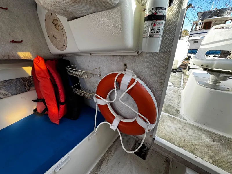 Slide: The Image of 2001 Aquasport 215 Explorer interior with life preserver, life jackets, and fire extinguisher. - 24