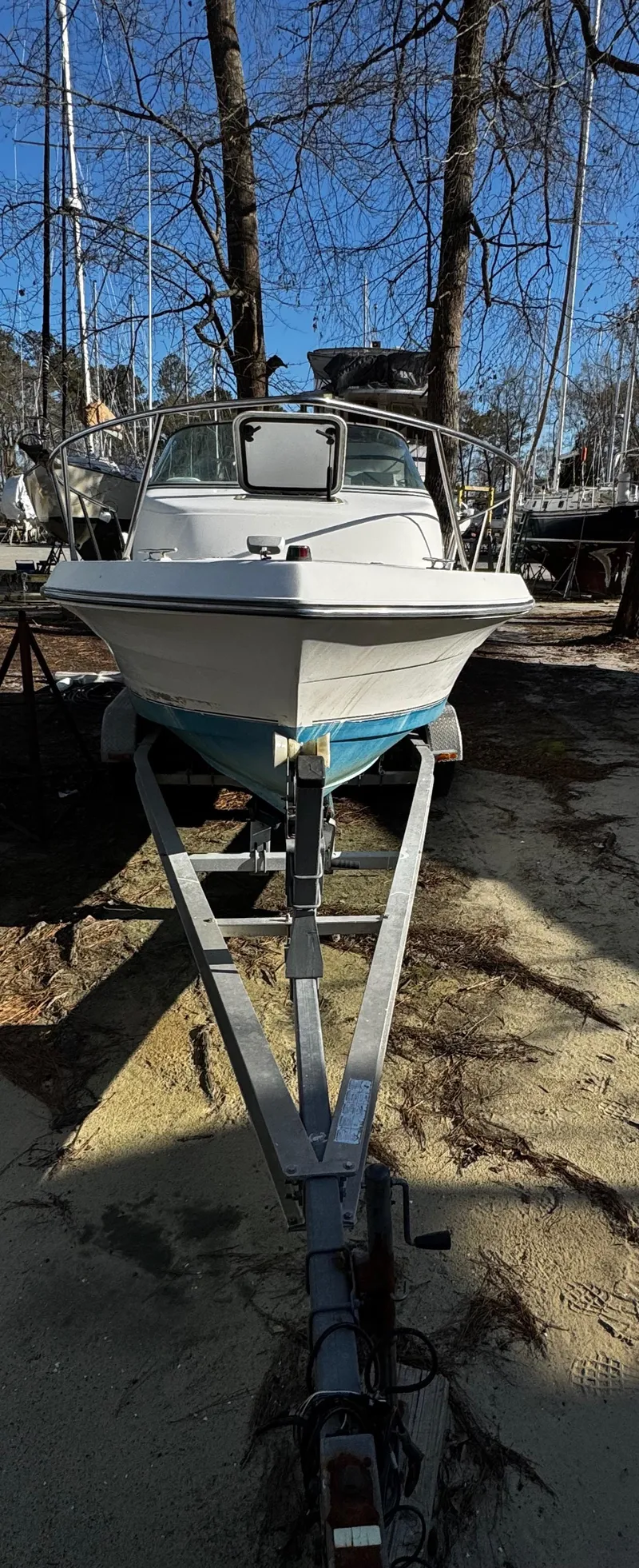 Slide: The Image of 2001 Aquasport 215 Explorer boat on trailer, parked outdoors. - 33