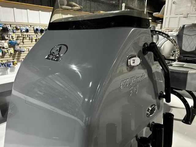 Slide: The Image of 2025 Blazer 675 Ultimate Bay boat console in showroom, featuring sleek design and branding. - 10