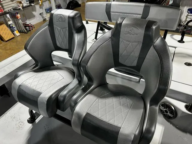 Slide: The Image of 2025 Blazer 675 Ultimate Bay boat seats with sleek, modern design in a workshop setting. - 12
