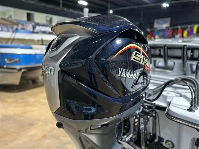 Slide: The Image of 2025 Blazer 675 Ultimate Bay with Yamaha outboard engine in showroom setting. - 15