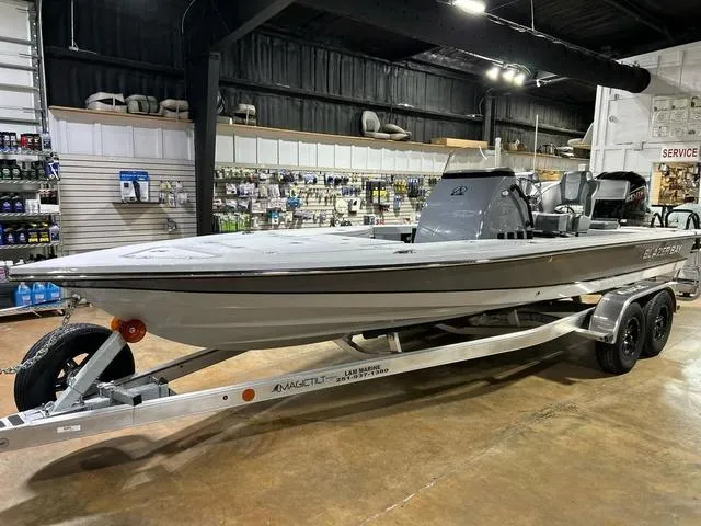 Slide: The Image of 2025 Blazer 675 Ultimate Bay boat on trailer in showroom setting. - 3