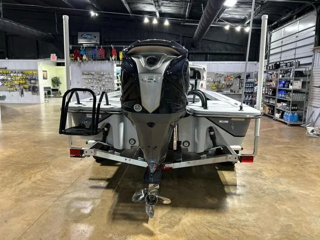 Slide: The Image of 2025 Blazer 675 Ultimate Bay boat in showroom, rear view with motor and accessories. - 5