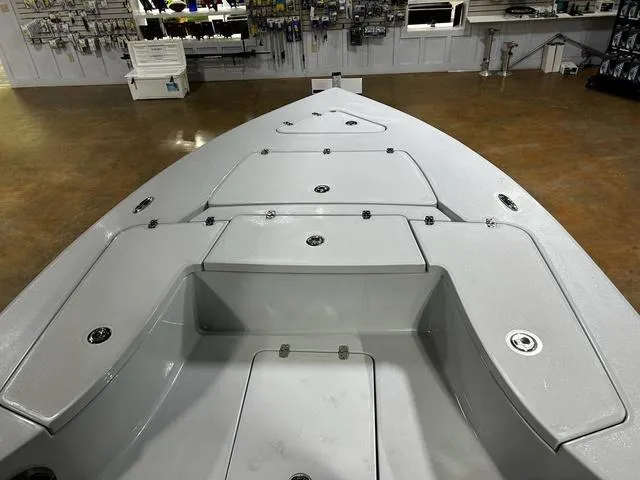 Slide: The Image of 2025 Blazer 675 Ultimate Bay boat interior with storage compartments in showroom. - 7