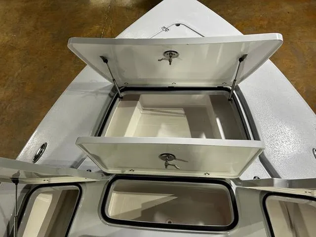 Slide: The Image of 2025 Blazer 675 Ultimate Bay boat with open storage compartments. - 8