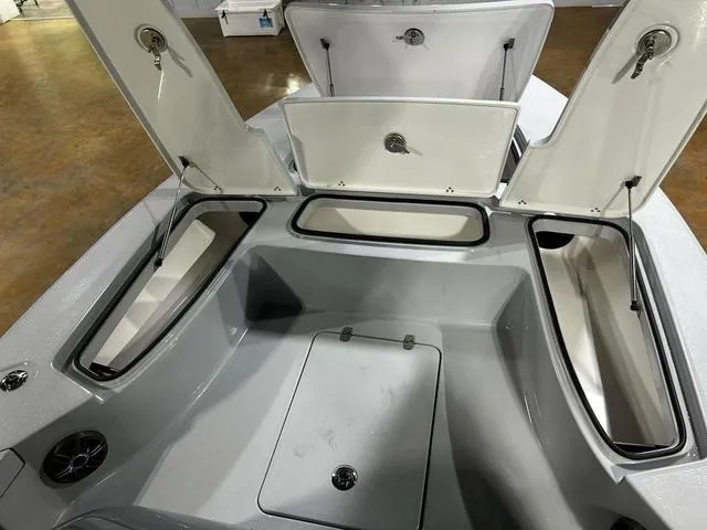 Slide: The Image of 2025 Blazer 675 Ultimate Bay boat storage compartments open, showcasing spacious interior design. - 9
