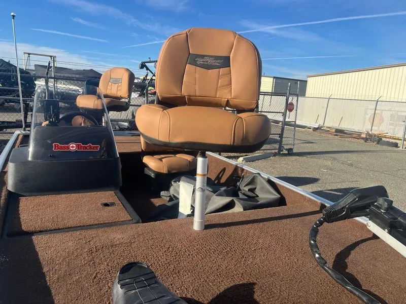 Slide: The Image of 2018 Tracker BASS TRACKER® 40th Anniversary Heritage Edition boat with tan seats and outdoor setting. - 10