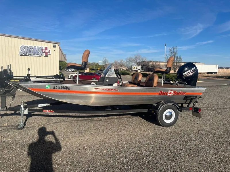 Slide: The Image of 2018 Tracker BASS TRACKER® 40th Anniversary Heritage Edition boat on trailer in parking lot. - 16