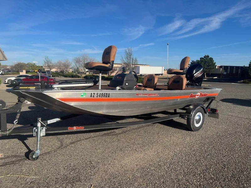 Slide: The Image of 2018 Tracker BASS TRACKER® 40th Anniversary Heritage Edition boat on trailer, parked outdoors. - 17