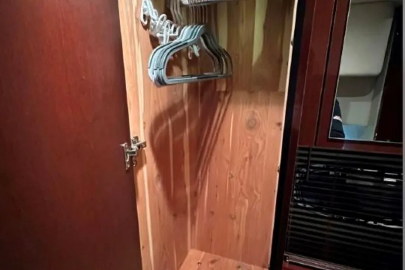 Slide: The Image of Wooden closet with hangers inside a 2011 Sea Ray 470 Sundancer yacht. - 21