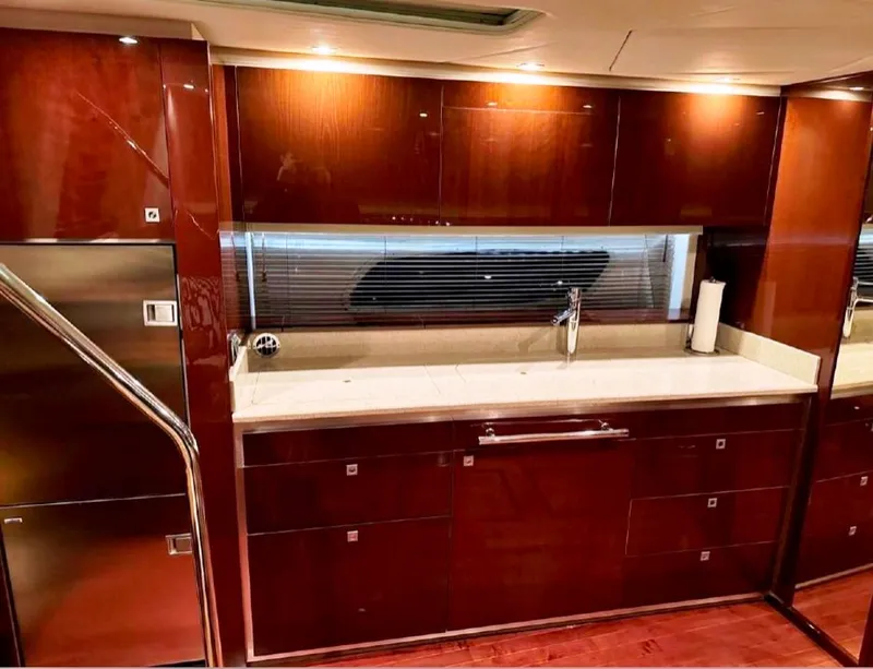 Slide: The Image of Luxurious kitchen interior of 2011 Sea Ray 470 Sundancer yacht with sleek cabinetry. - 23