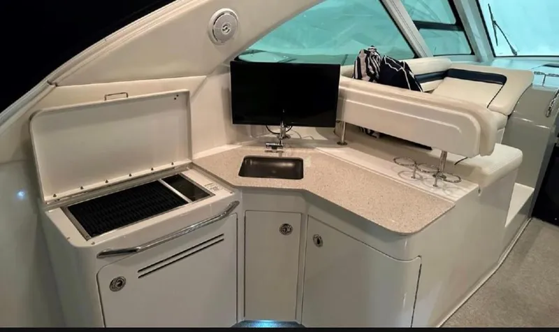 Slide: The Image of Interior of 2011 Sea Ray 470 Sundancer yacht with kitchenette and seating area. - 25