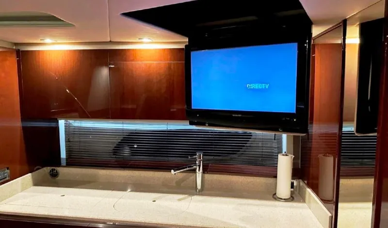 Slide: The Image of Luxurious interior of 2011 Sea Ray 470 Sundancer with TV and modern sink. - 26