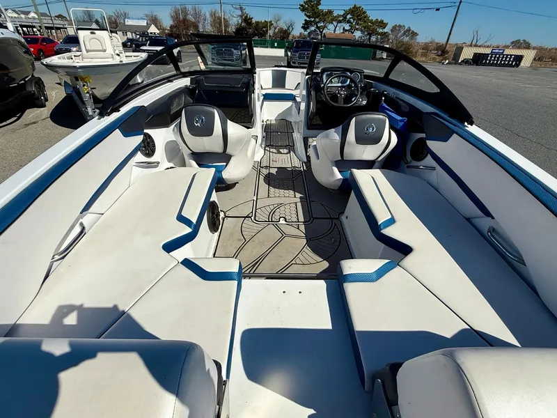 Slide: The Image of 2020 Scarab 215 ID boat interior with white seating and modern dashboard. - 11
