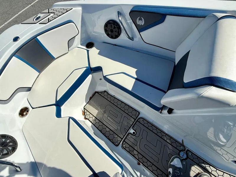 Slide: The Image of 2020 Scarab 215 ID boat interior with white and blue seating and speakers. - 14