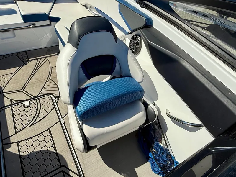 Slide: The Image of 2020 Scarab 215 ID boat interior with blue and white seating and modern design. - 19