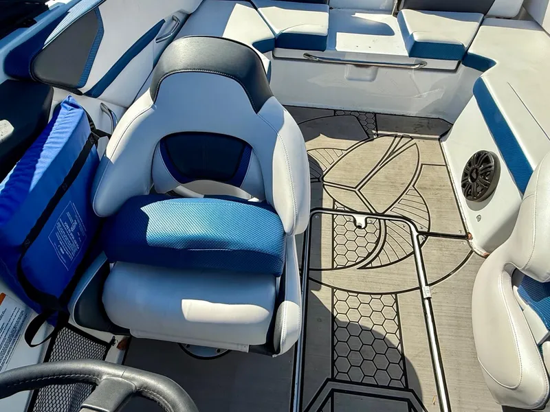 Slide: The Image of Interior of a 2020 Scarab 215 ID boat with blue and white seating. - 2
