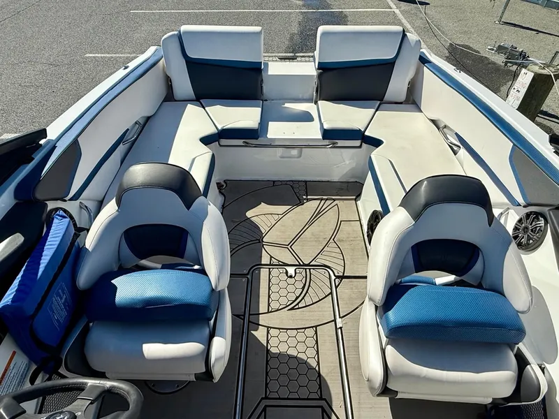 Slide: The Image of 2020 Scarab 215 ID boat interior with white and blue seating, modern design. - 3