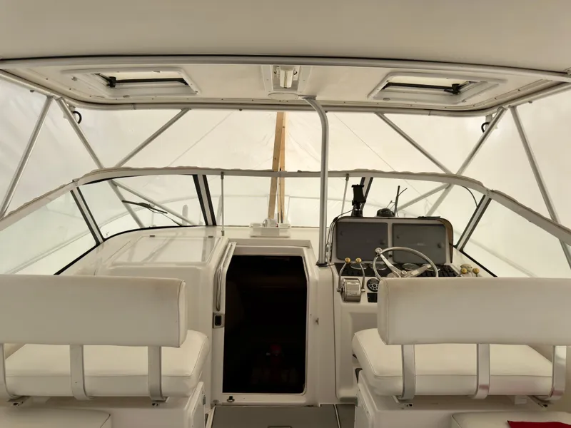Slide: The Image of 2005 Luhrs 30 Hard Top boat interior with helm and seating. - 10
