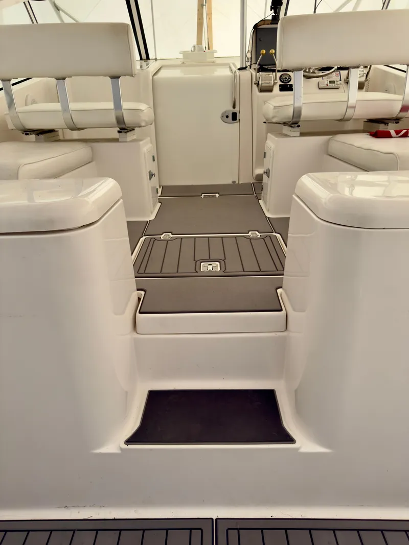 Slide: The Image of 2005 Luhrs 30 Hard Top boat interior with white seating and sleek flooring. - 11