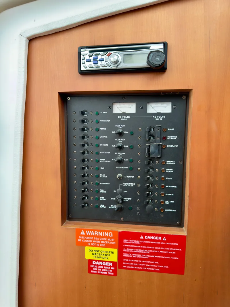 Slide: The Image of Electrical control panel on a 2005 Luhrs 30 Hard Top boat with stereo system. - 15