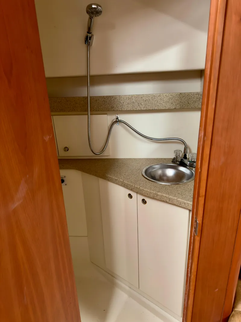 Slide: The Image of 2005 Luhrs 30 Hard Top boat interior with sink and showerhead. - 18