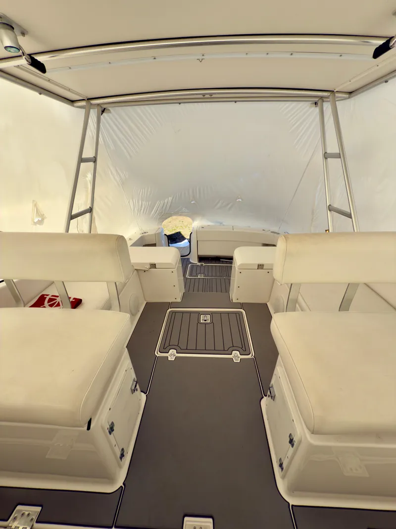 Slide: The Image of 2005 Luhrs 30 Hard Top boat interior with cushioned seating and storage. - 6