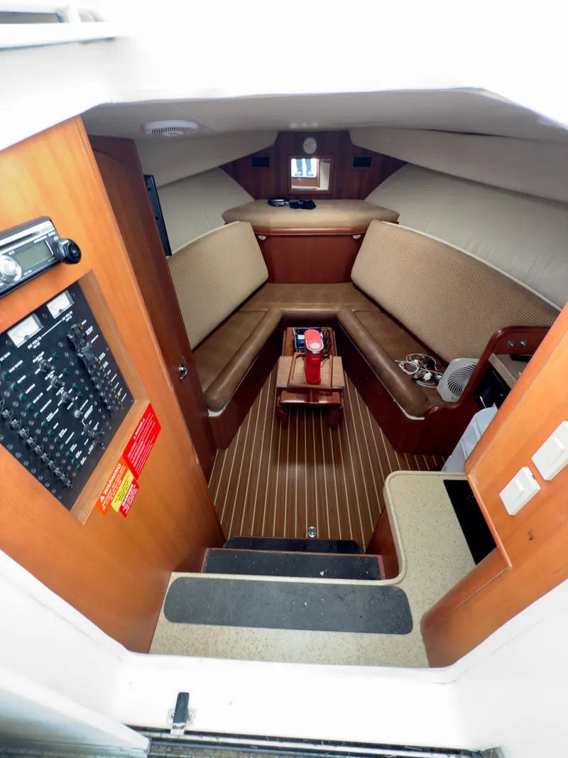 Slide: The Image of 2005 Luhrs 30 Hard Top cabin interior with seating and control panel. - 7