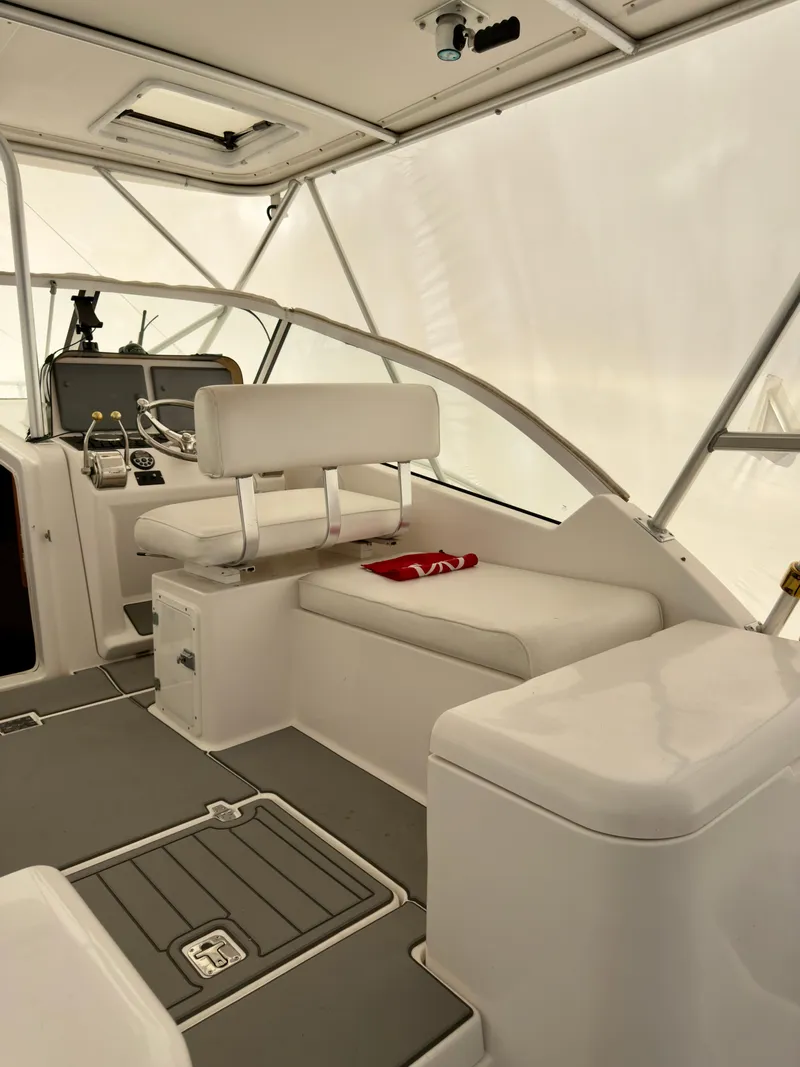 Slide: The Image of 2005 Luhrs 30 Hard Top boat interior with helm and seating area. - 8
