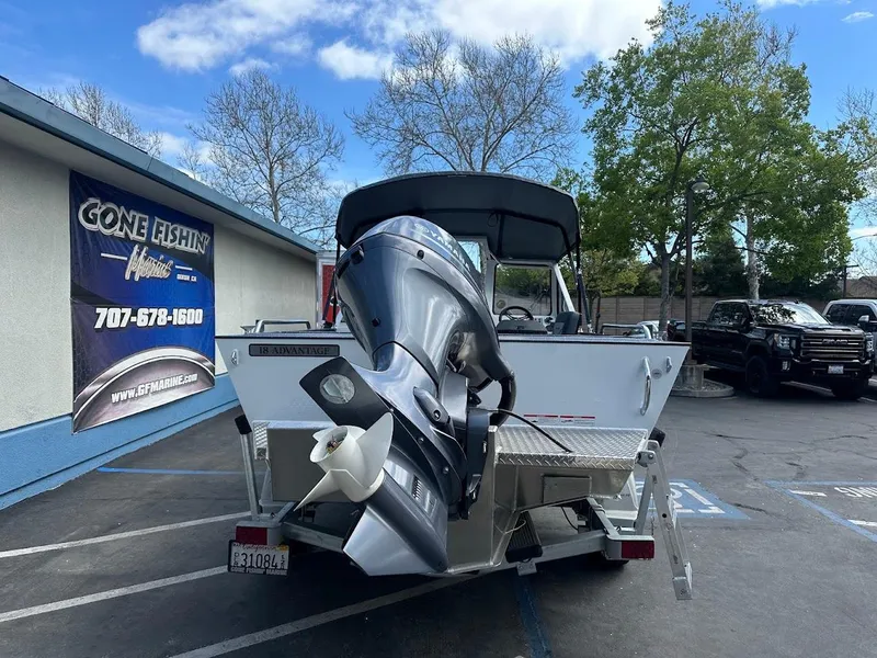 Slide: The Image of 2025 Duckworth 18 Advantage boat with outboard motor in parking lot. - 10