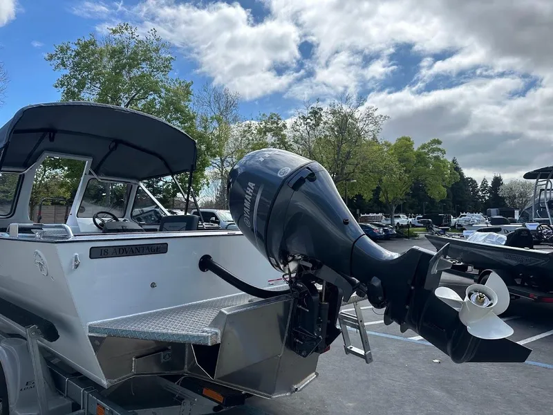 Slide: The Image of 2025 Duckworth 18 Advantage boat with outboard motor in a parking lot. - 11