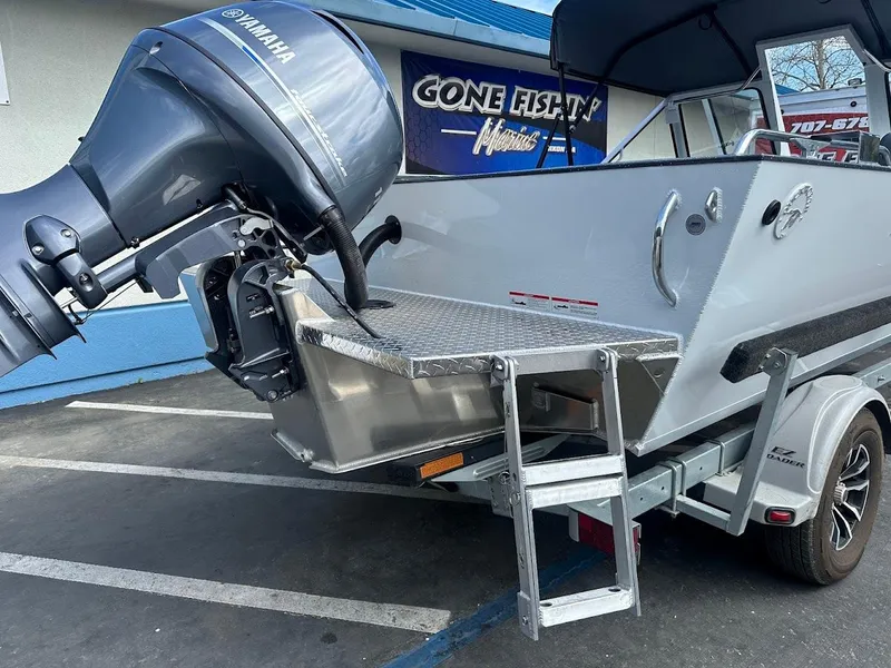 Slide: The Image of 2025 Duckworth 18 Advantage boat with Yamaha motor, parked near "Gone Fishin'" sign. - 12