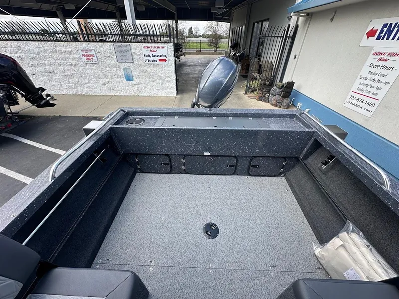 Slide: The Image of 2025 Duckworth 18 Advantage boat interior with spacious deck and motor, parked outdoors. - 15