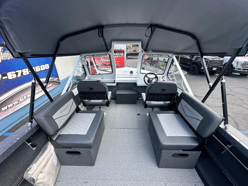 Slide: The Image of Interior of 2025 Duckworth 18 Advantage boat with seating and steering console. - 16