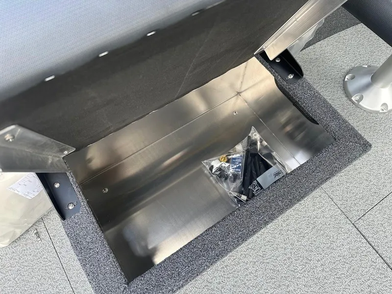 Slide: The Image of Storage compartment in 2025 Duckworth 18 Advantage boat, featuring metal interior and accessories. - 18