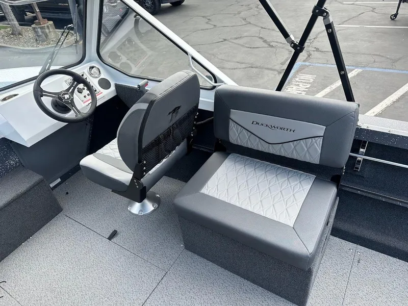 Slide: The Image of 2025 Duckworth 18 Advantage boat interior with modern seating and steering wheel. - 19