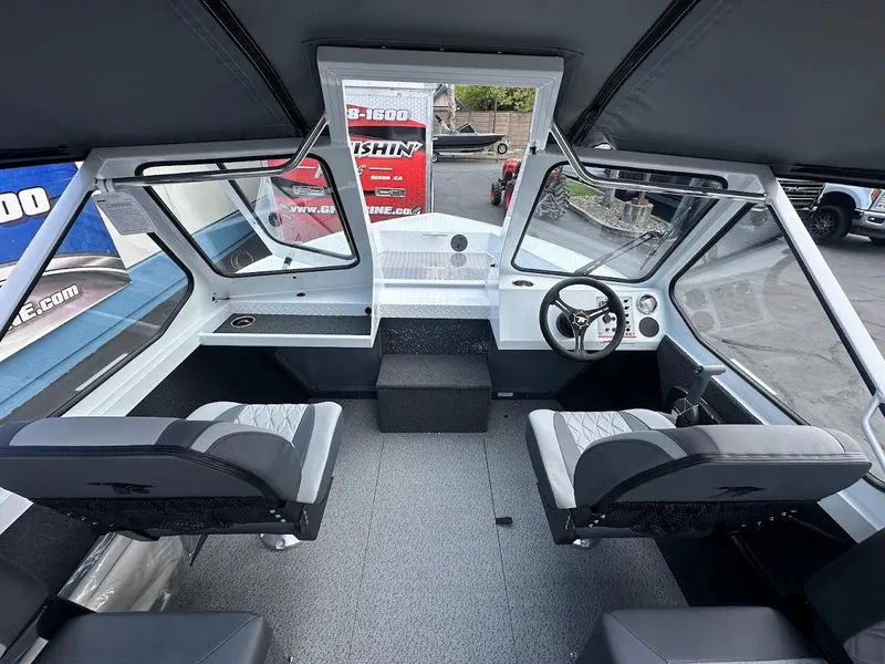 Slide: The Image of Interior of a 2025 Duckworth 18 Advantage boat with modern seating and dashboard. - 21