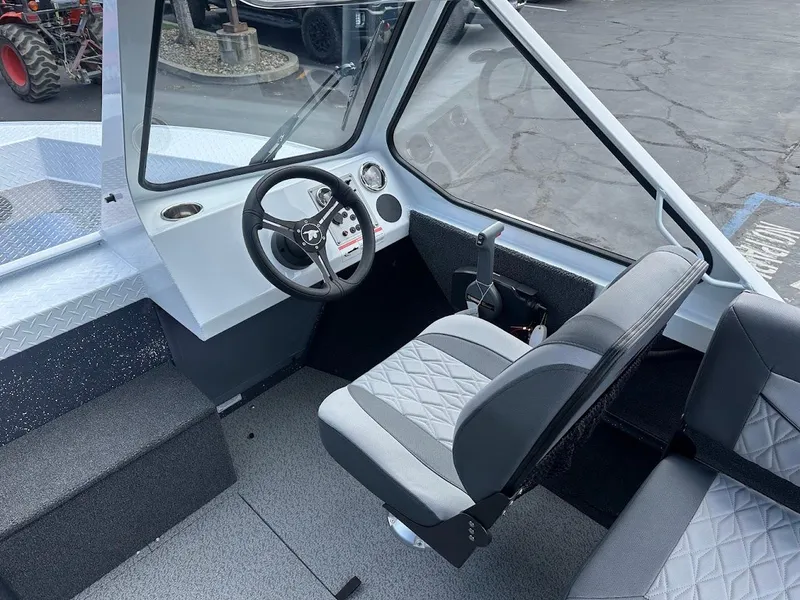 Slide: The Image of 2025 Duckworth 18 Advantage boat interior with steering wheel and seating. - 23
