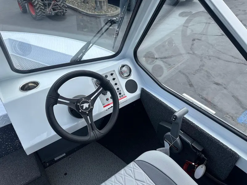 Slide: The Image of Interior view of 2025 Duckworth 18 Advantage boat cockpit with steering wheel and controls. - 24