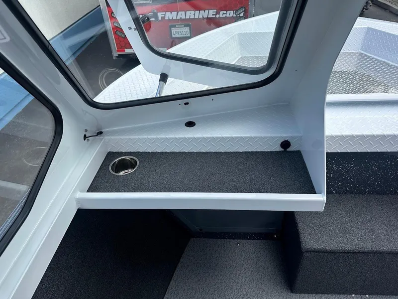 Slide: The Image of Interior of 2025 Duckworth 18 Advantage boat with cup holder and window view. - 26