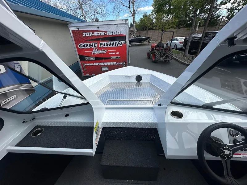 Slide: The Image of 2025 Duckworth 18 Advantage boat interior with steering wheel, trailer, and equipment in background. - 27