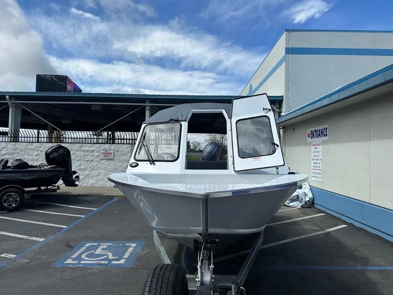 Slide: The Image of 2025 Duckworth 18 Advantage boat parked in a lot under a cloudy sky. - 3