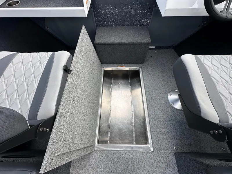 Slide: The Image of 2025 Duckworth 18 Advantage boat interior with open storage compartment between two seats. - 31